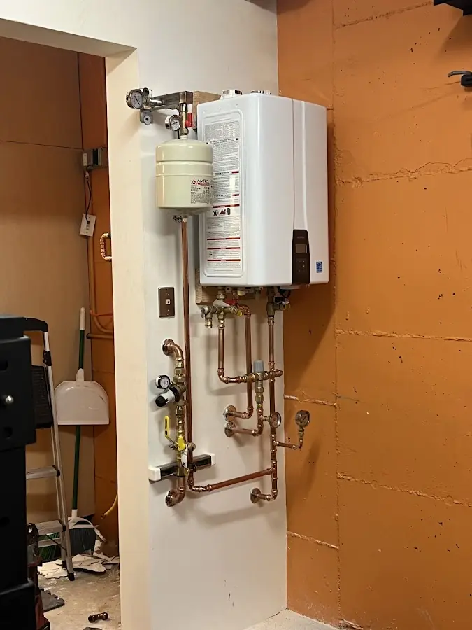 Plumbing technician inspecting water heater connections in Palmetto Bay